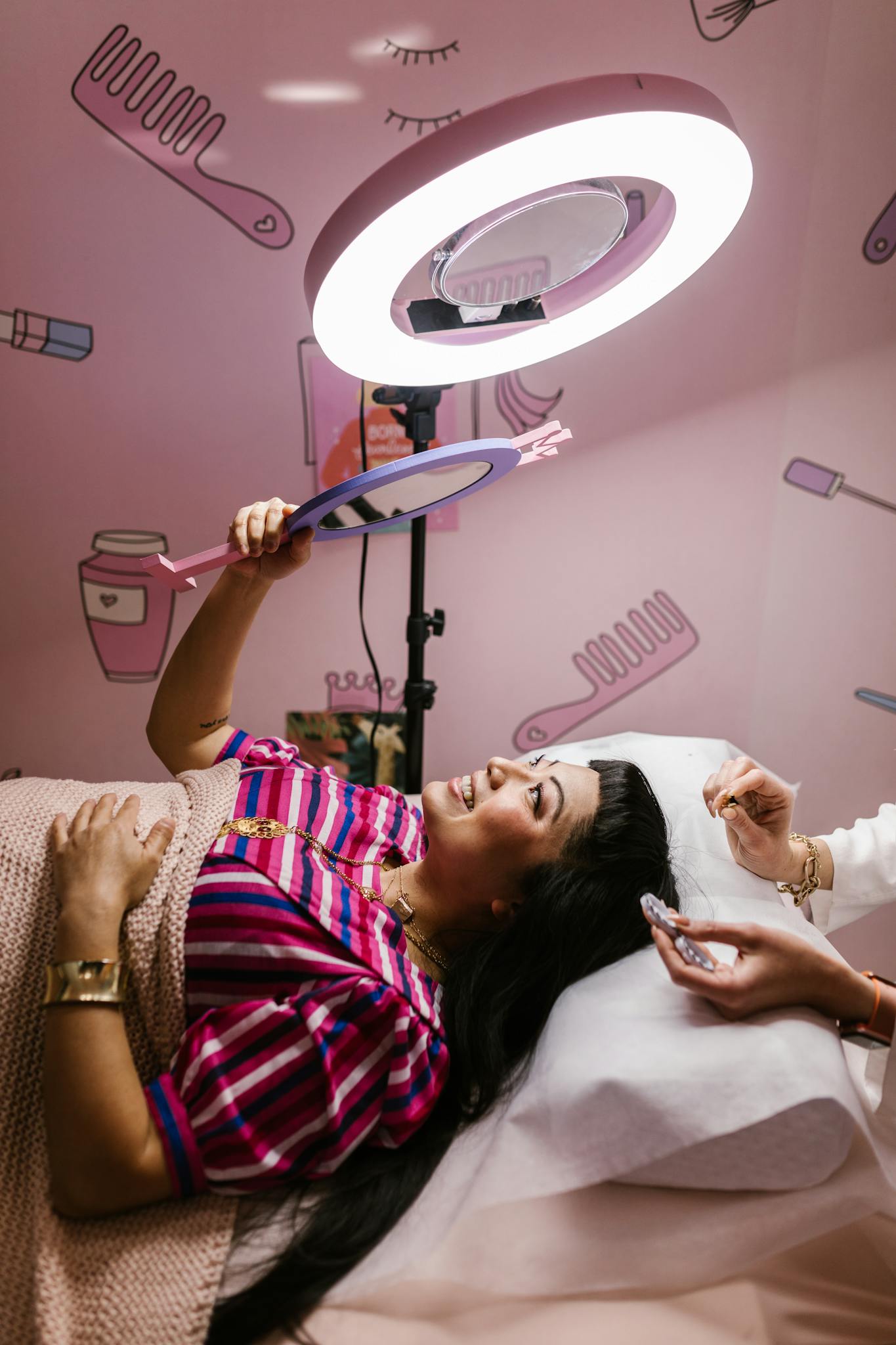 A woman enjoys a beauty treatment in a modern salon setting.